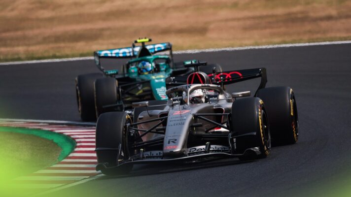 Nico Hulkenberg's Audi on track, snaking its way through the opening sequence in Suzuka pursued by Fernando Alonso driving an Aston Martin.