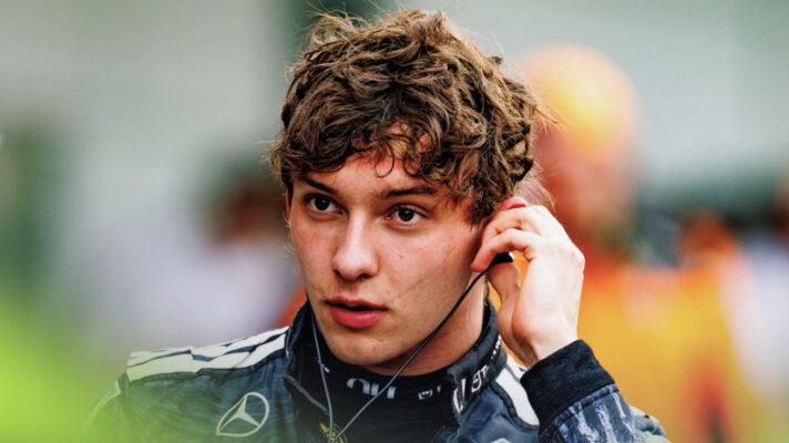 An exhausted looking Kimi Antonelli removes his ear piece having just climbed from his Mercedes and taken off his helmet.