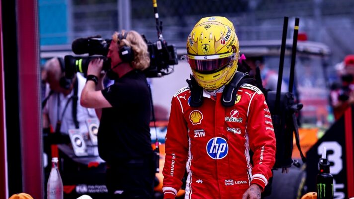 Lewis Hamilton walks down the pit lane