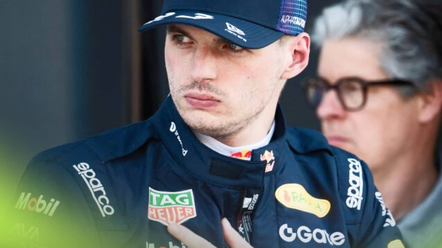 Max Verstappen looks on in parc ferme with his hand held to his chest