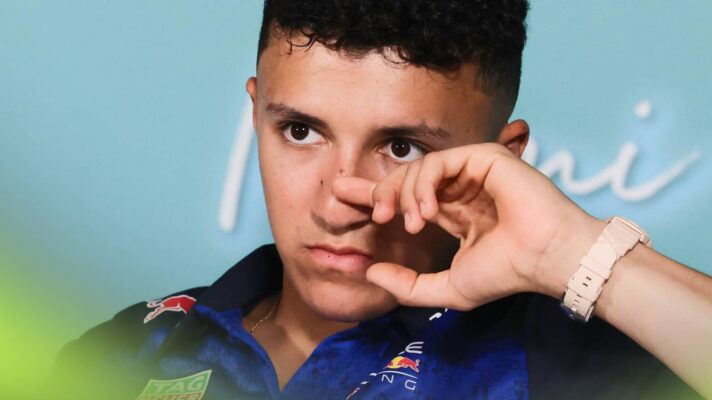 Isack Hadjar raises his hand to his face as he looks on in a press conference in Miami