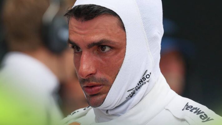 A close-up shot of Carlos Sainz wearing a balaclava