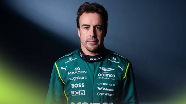 A studio shot of Fernando Alonso posing in 2026 Aston Martin overalls