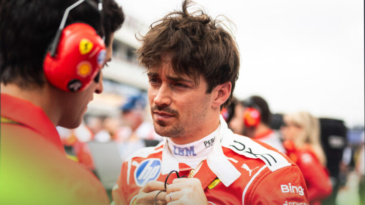 A pensive looking Charles Leclerc speaks to his engineer on the grid ahead of the Miami Grand Prix.