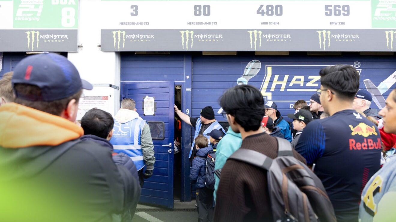 A crowd forms outside Max Verstappen's team garage at the 24 Hours of Nürburgring