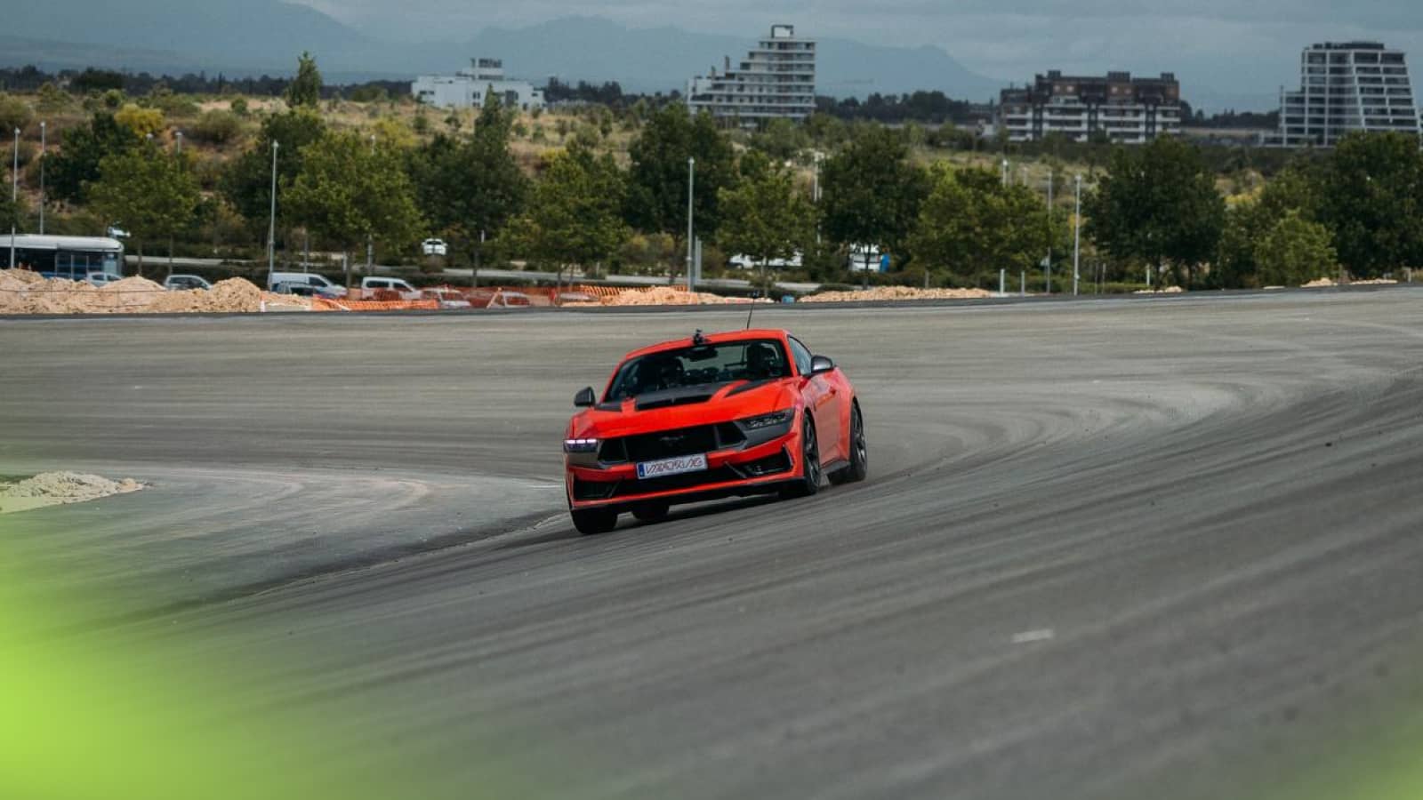 Carlos Sainz behind the wheel of a red Ford Mustang GT car on the new Madring circuit