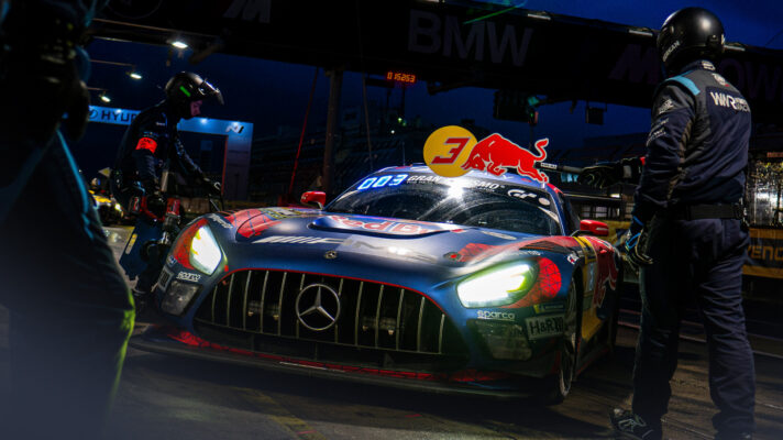 Max Verstappe's car enters its pit box during the night at the Nürburgring 24 Hours.
