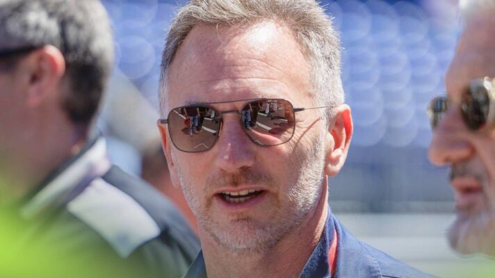 Christian Horner in conversation in the Monaco Formula E paddock while wearing sunglasses