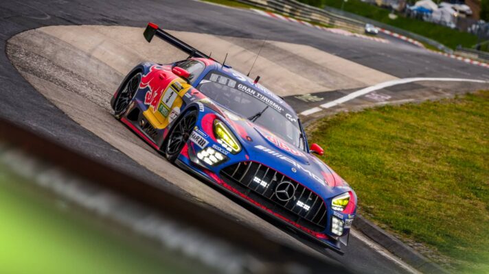 Max Verstappen drives a Red Bull-branded Mercedes-AMG GT3 car through the Karussell corner at the Nordschleife