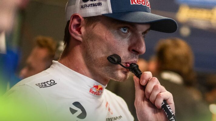 Max Verstappen drinks from a straw in the garage at the Nürburgring 24 Hours