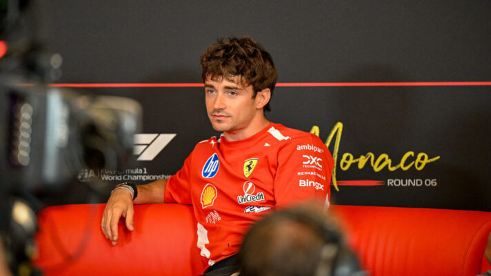 Charles Leclerc relaxed in a press conference with his arm over the back of the couch