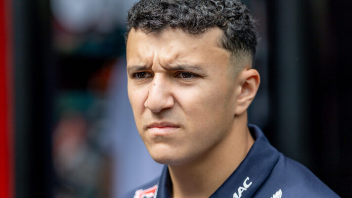 Isack Hadjar frowning in the paddock