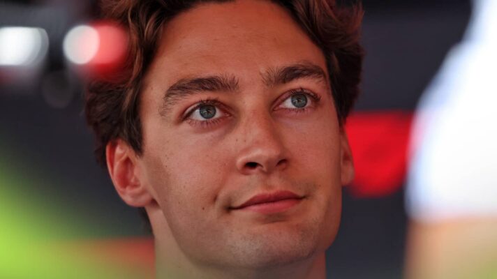 A close-up shot of George Russell looking upwards