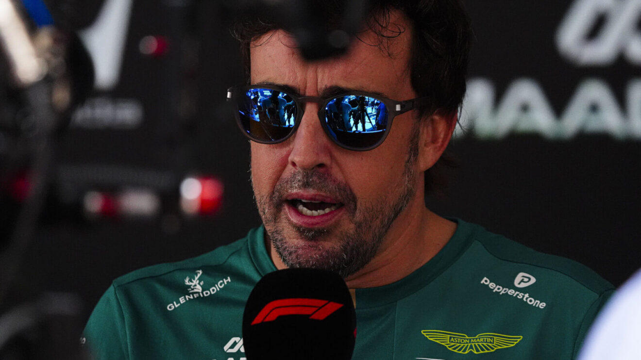 Fernando Alonso wearing sunglasses while interviewed, F1 mic