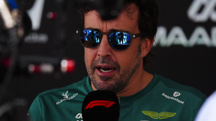 Fernando Alonso wearing sunglasses while interviewed, F1 mic
