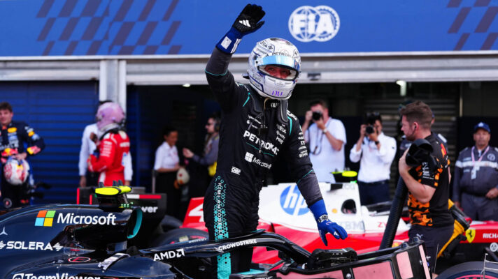 Kimi Antonelli raises a fist in celebration as he climbs out of his Mercedes W17