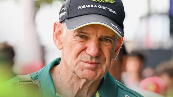 A close-up shot of Adrian Newey wearing a green Aston Martin shirt and a branded black cap