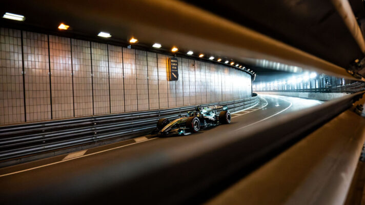 Lance Stroll flying through the tunnel at the Monaco Grand Prix in his Aston Martin AMR26, lights blazing