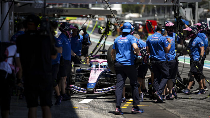 Pierre Gasly pulls into the Alpine pit box, surrounded by mechanics