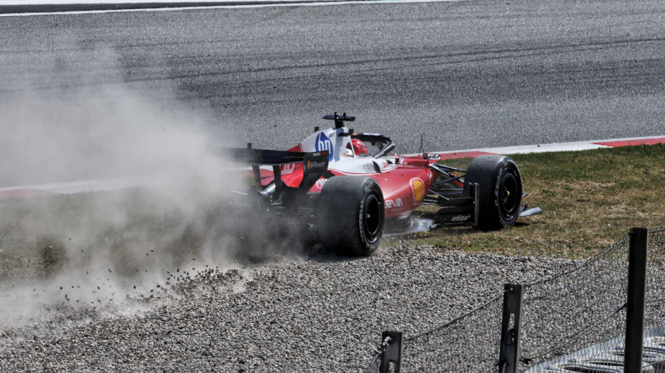 Charles Leclerc kicks up gravel off track after losing power steering, plume of gravel and dust behind his Ferrari