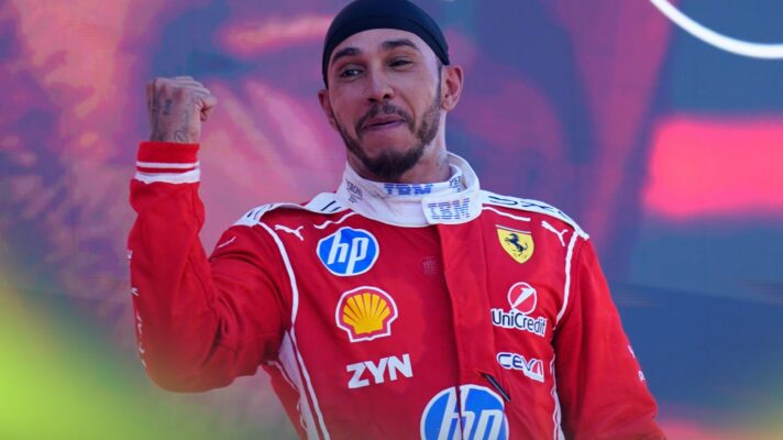 Lewis Hamilton, Ferrari, raises a celebratory fist on the podium after winning the 2026 Barcelona-Catalunya Grand Prix