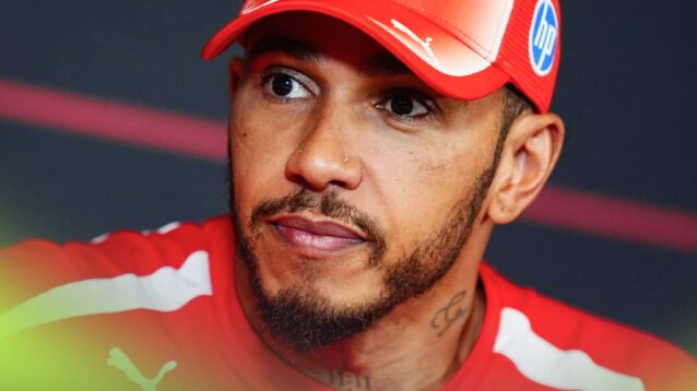A close-up shot of Lewis Hamilton wearing Ferrari uniform in a press conference
