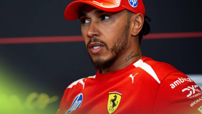 Lewis Hamilton glances to the side in a press conference