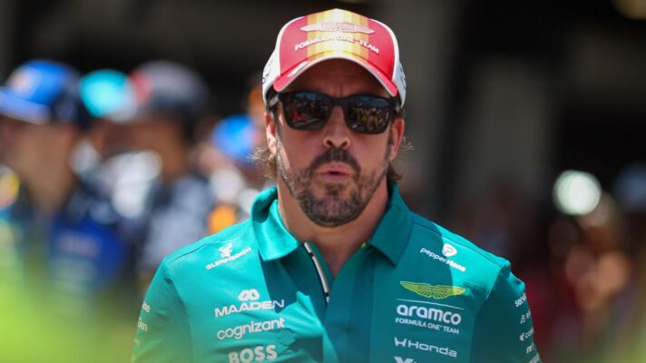 Fernando Alonso walks through the paddock in Barcelona.