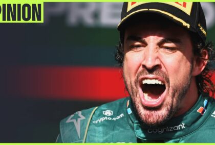 Fernando Alonso with his mouth wide open in celebration on the podium with an 'opinion' tab in the top-left corner