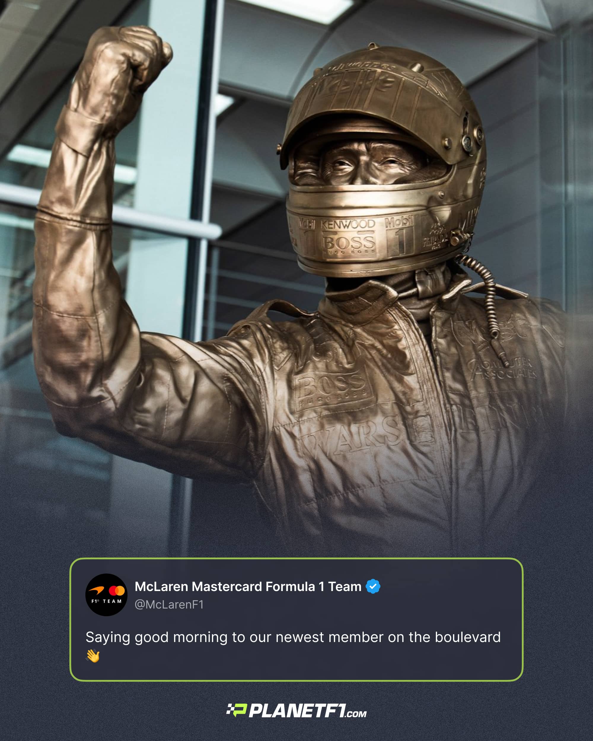 A bronze statue of Mika Hakkinen in a celebratory pose