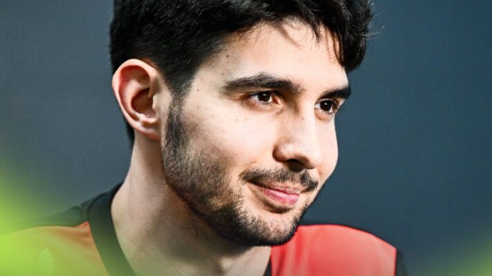 Esteban Ocon looks on while facing the media