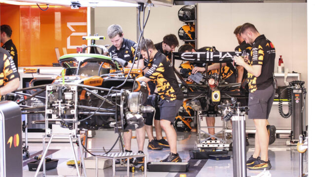 McLaren mechanics in the garage working on the MCL40