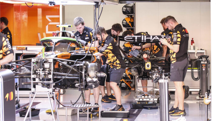 McLaren mechanics in the garage working on the MCL40