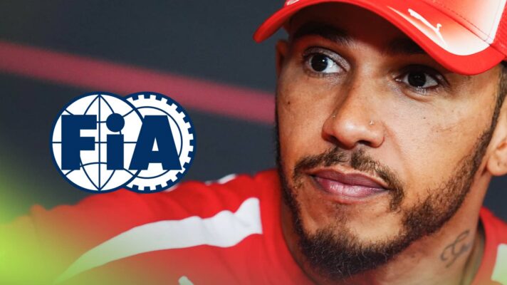 A close-up shot of Lewis Hamilton wearing Ferrari uniform with a prominent FIA logo alongside him