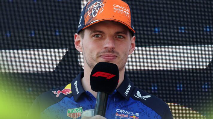 Max Verstappen, Red Bull, speaks into an 'F1' microphone at the 2026 Austrian Grand Prix