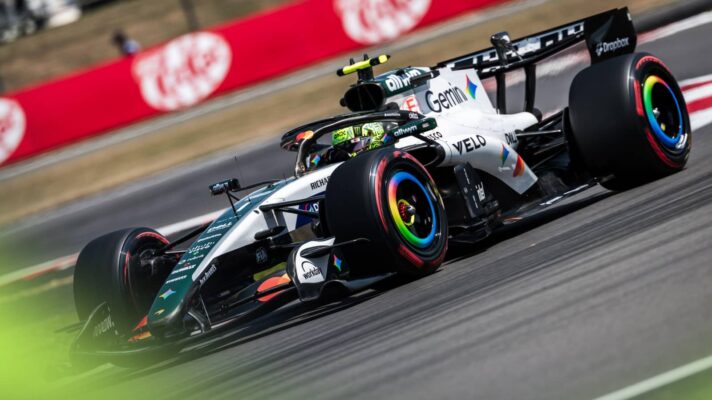 An action shot of Lando Norris's McLaren on track in a special white livery at Silverstone