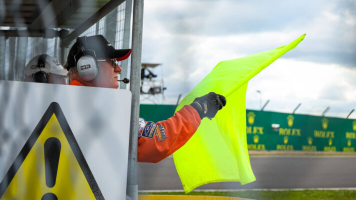 Marshal waves a yellow flag at the Silverstone circuit