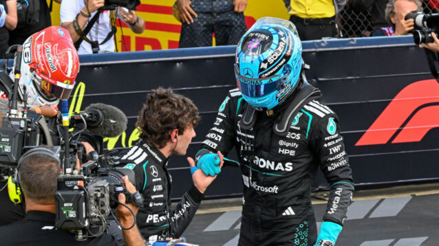 George Russell congratulates Kimi Antonelli in front of the cameras, Charles Leclerc in the background