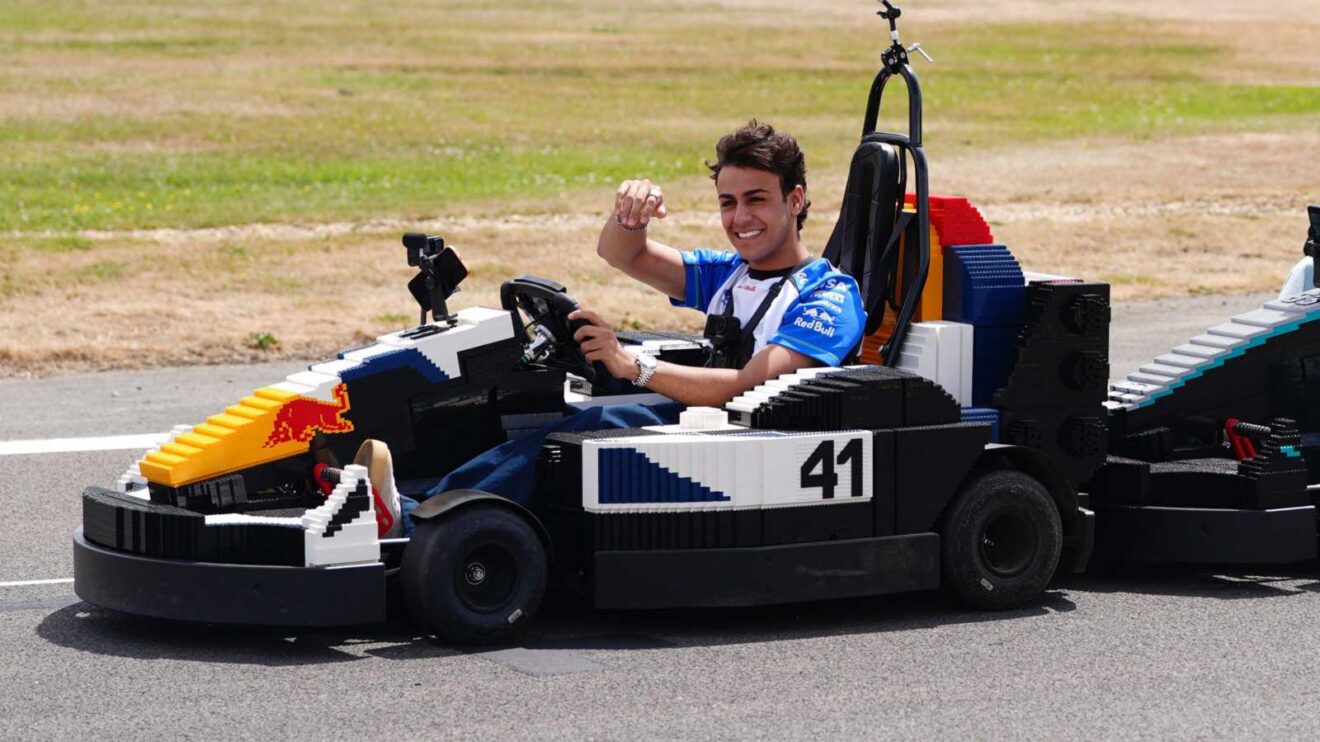 Racing Bulls driver Arvid Lindblad drives a LEGO car ahead of the British GP.