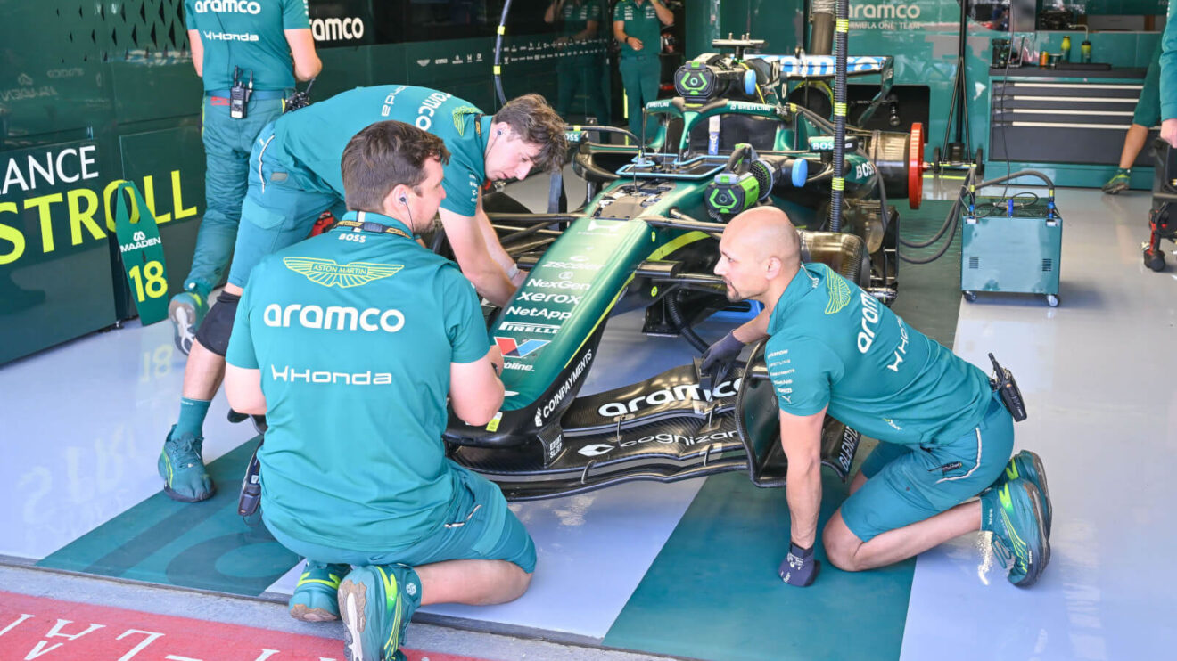 Aston Martin mechanics working on Lance Stroll's AMR26 in the garage