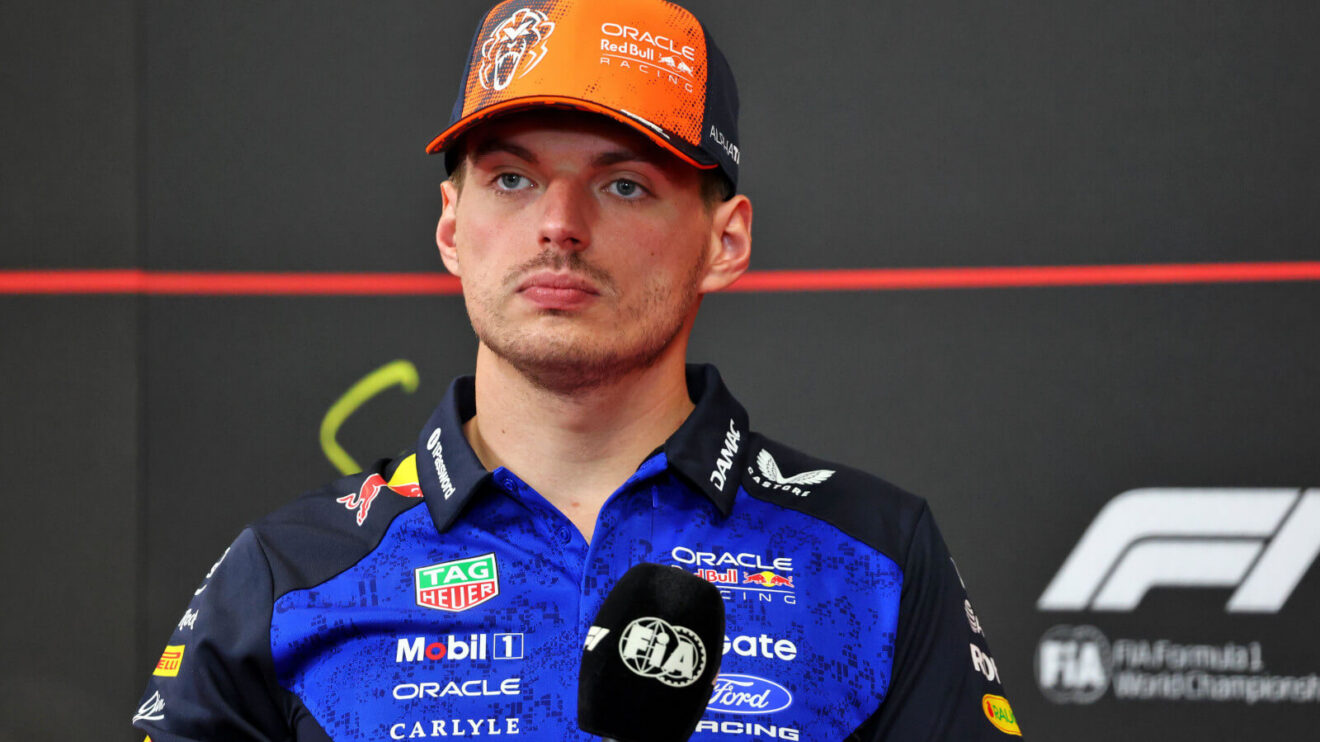Max Verstappen stone face press conference, holding the mic