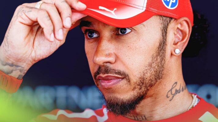 A close-up shot of Lewis Hamilton pinching the peak of his cap