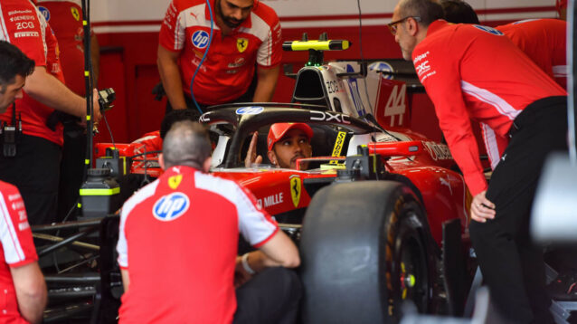 Lewis Hamilton in the cockpit of his Ferrari SF-26, surrounded by team personnel