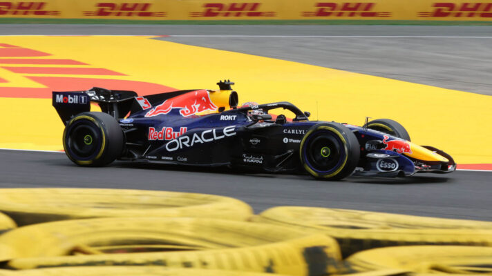 Max Verstappen lapping Spa in the Red Bull with a tyre barrier in the foreground