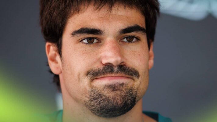 A close-up shot of Lance Stroll facing the media