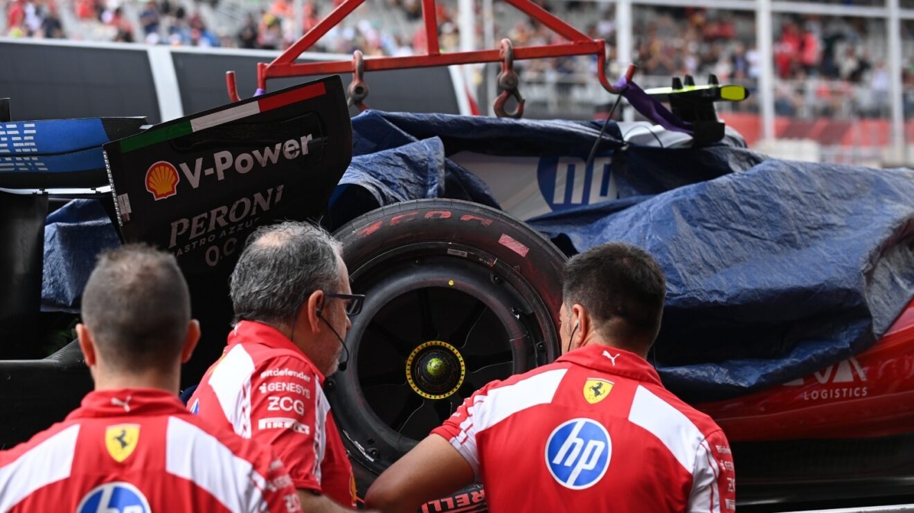 Lewis Hamilton's crashed SF-26 is returned to Ferrari in the pit lane
