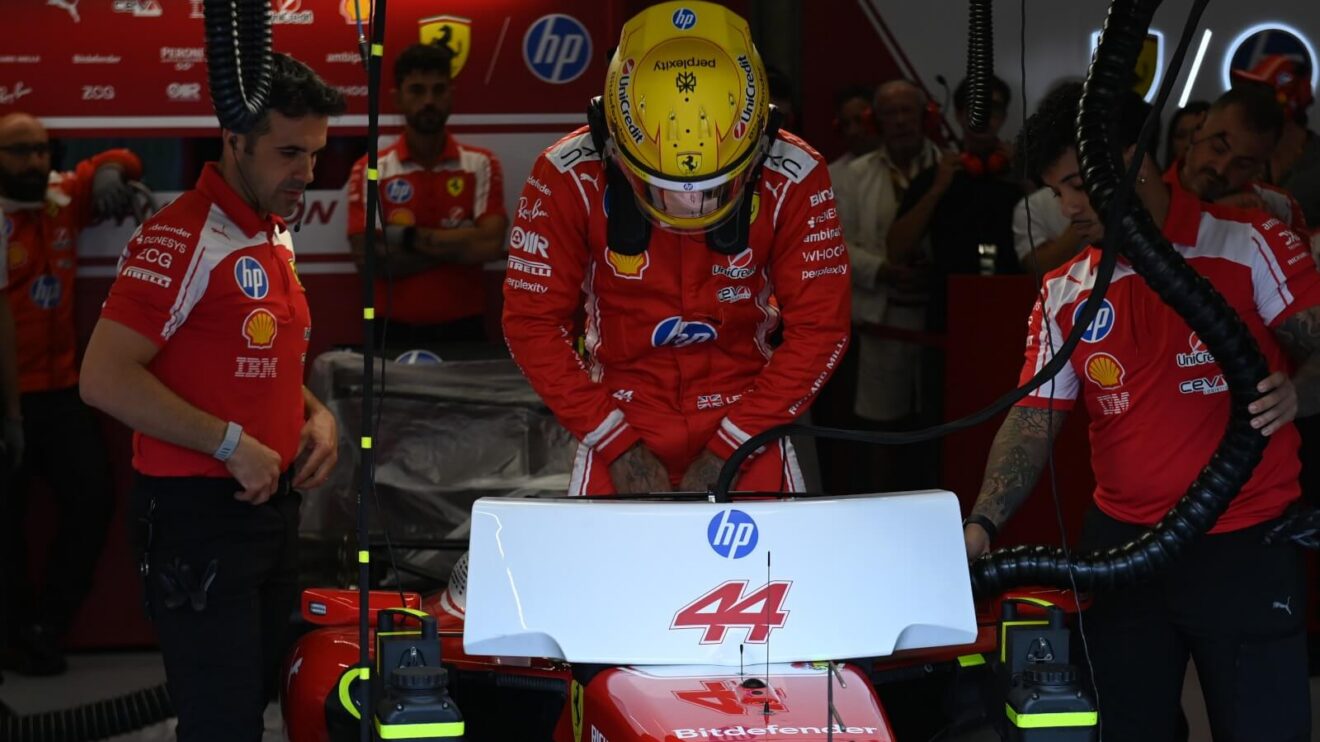 Lewis Hamilton climbs into his Ferrari SF-26.