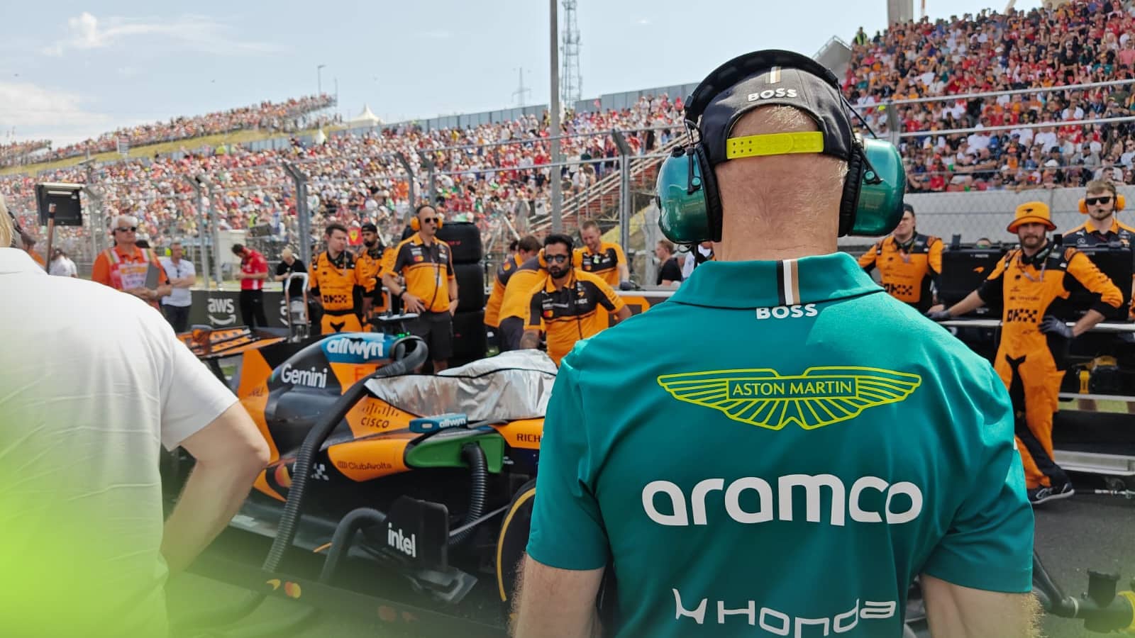An over-the-shoulder shot of Adrian Newey studying the McLaren on the grid in Budapest
