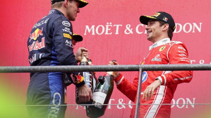 Max Verstappen, Red Bull and Charles Leclerc, Ferrari, tap bottles in celebration on the 2026 Belgian Grand Prix podium