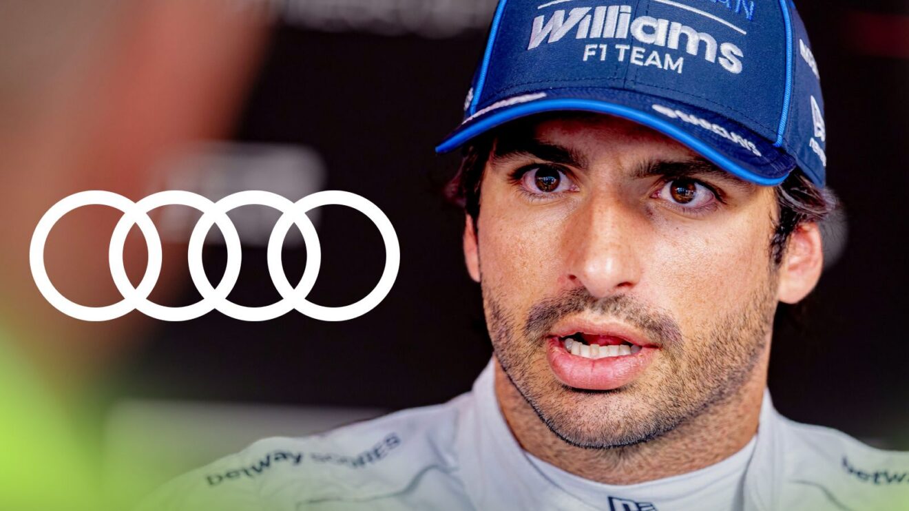 Carlos Sainz, Williams, speaking at the 2026 Belgian Grand Prix, as the Audi logo appears on the left
